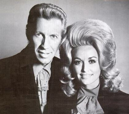 Black-and-white 1971 publicity portrait of Porter Wagoner and Dolly Parton, cropped close, both facing the camera.
